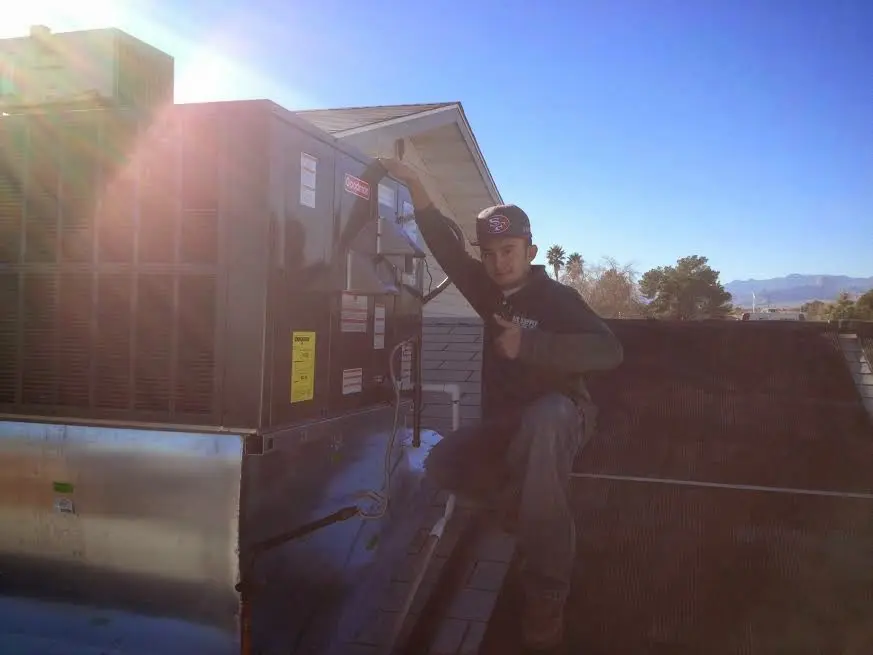 HVAC technician performing HVAC Inspection on a rooftop unit in Spring Lake